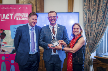 Pictured; Steve Brine MP with Bryden Joy as he receives his award.